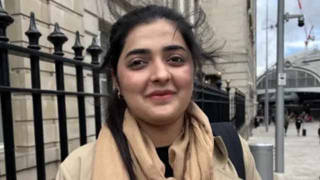 Shafaq is pictured outside Paddington Station ,with her hair blown by the wind