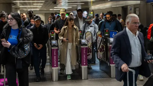 Commuters pass through the ticket gates at King's Cross St Pancras underground station