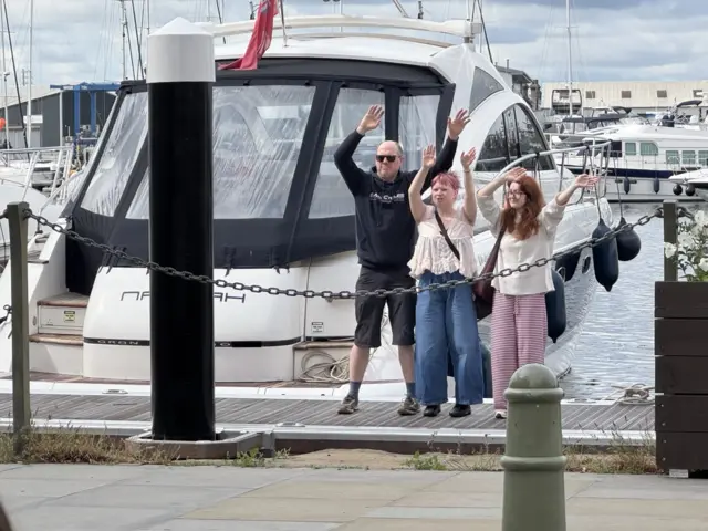 Fans stood on the boardwalk, with their hands raised