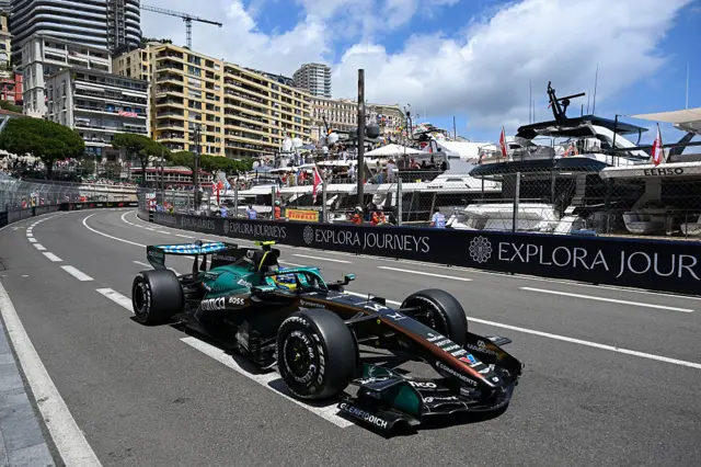 Fernando Alonso drives past the harbour in Monaco