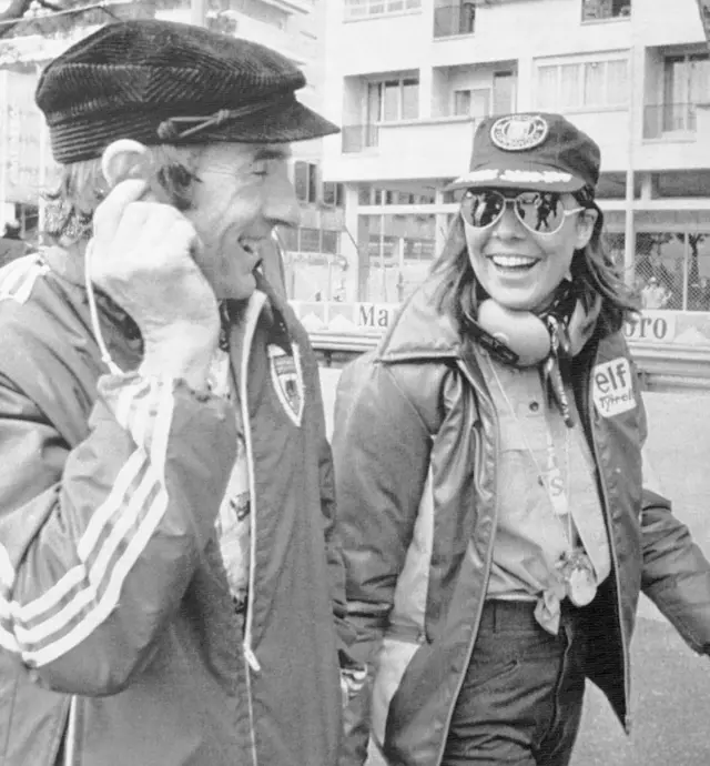 Princess Caroline of Monaco and three-time world driving champion Jackie Stewart share a joke as they walk through the pit area of the Monaco Grand Prix circuit