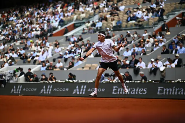 Jakub Mensik plays a backhand return