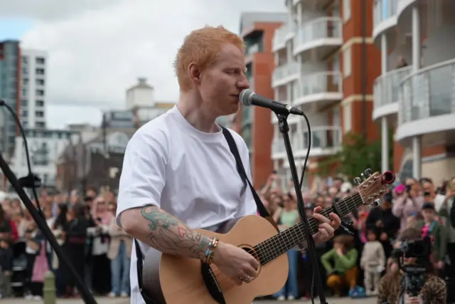 Ed singing with his guitar
