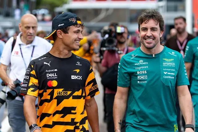 Lando Norris and Fernando Alonso in the paddock in Monaco