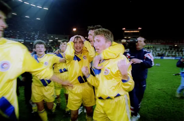 Romania celebrate qualifying after the Paul Bodin penalty miss game