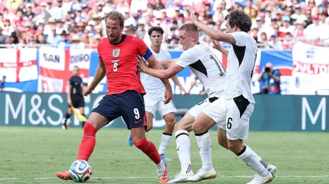 Harry Kane #9 of England is challenged by Finn Surman and Joe Bell #6 of New Zealand during the international friendly match between England and New Zealand