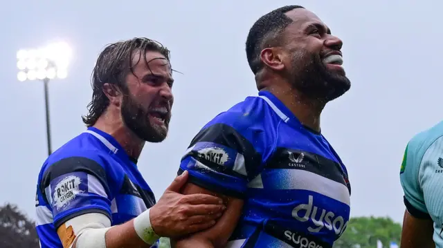 Joe Cokanasiga wearing a blue and white Bath shirt smiles