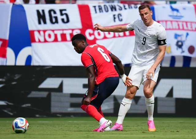 hris Wood #9 of New Zealand shoots past Marc Guehi #6 of England during the international friendly match between England and New Zealand