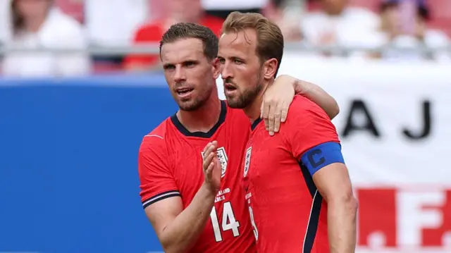 Harry Kane #9 of England celebrates with teammate Jordan Henderson after scoring his team's first goal during the international friendly match between England and New Zealand