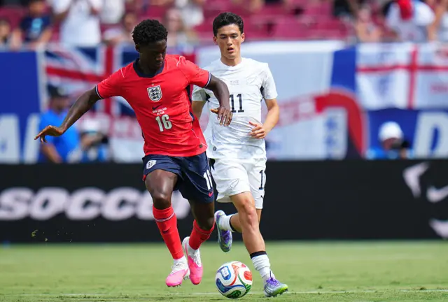 Kobbie Mainoo #16 of England is challenged by Elijah Just #11 of New Zealand during the international friendly match between England and New Zealand