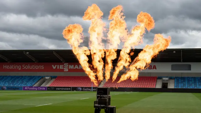 Flames shoot into the sky at Sale's ground