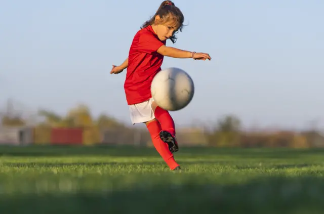 girl playing football
