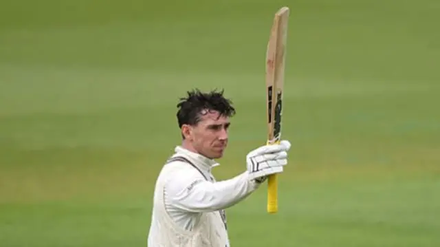 Dan Lawrence raises his bat