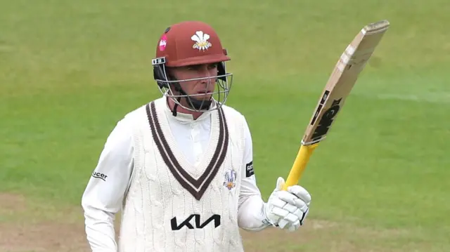 Dan Lawrence raises his bat