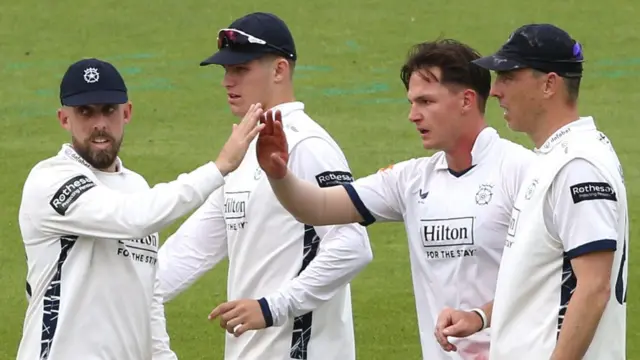 Sonny Baker is congratulated after the wicket of Ollie Pope