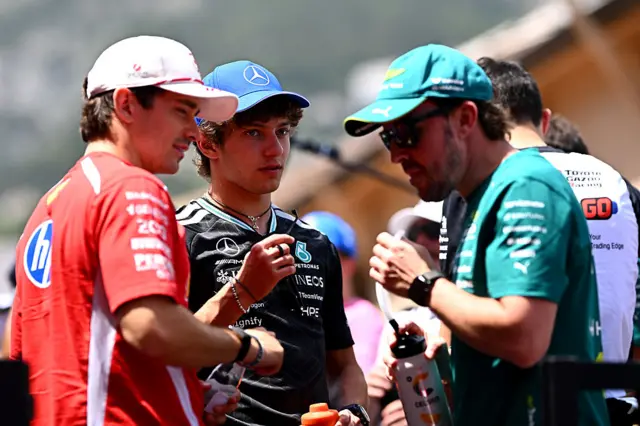 Charles Leclerc, Kimi Antonelli and Fernando Alonso chat during the drivers' parade