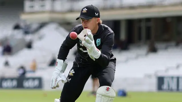 Ollie Pope warming up with wicketkeeping gloves at The Oval