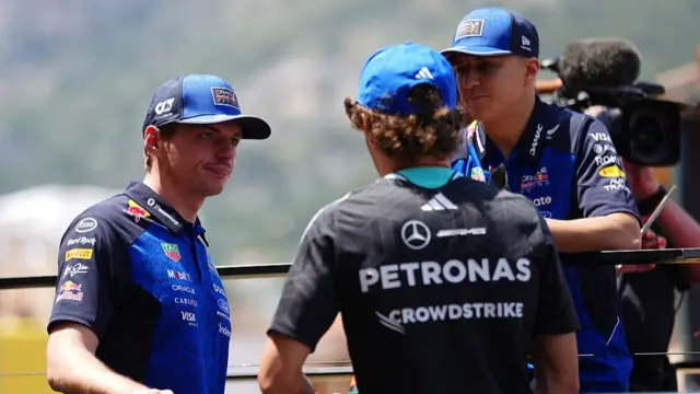Max Verstappen speaking to team-mate Isack Hadjar and Kimi Antonelli