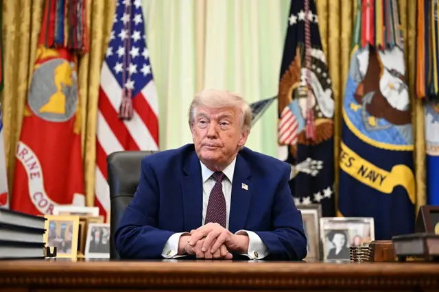 Trump speaks to the press in the Oval Office,