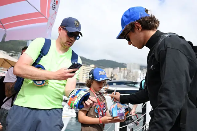 Kimi Antonelli signs autographs for a young fan