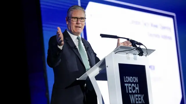 A photo of Keir Starmer stood at a podium, speaking at London Tech Week
