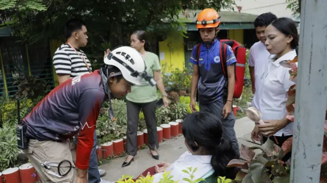 Emergency response personnel talk to a student who felt unwell