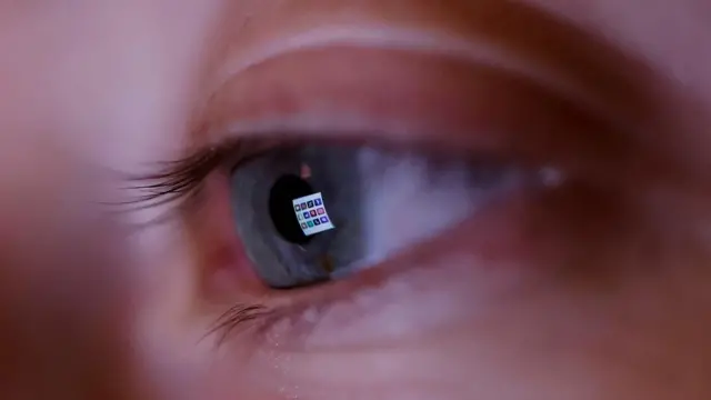 Social media apps reflected in an eye