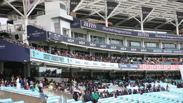 School children gather under cover at the Oval
