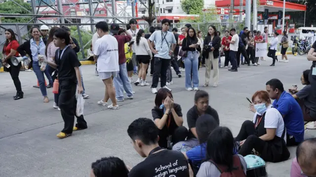 People gather at open spaces outside a commercial complex