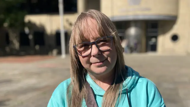 Karen Bentham outside Bradford Crown Court, wearing a turquoise hoodie