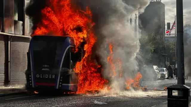 A Glider bus, set fire by protesters, on the Newtownards Road in east Belfast.