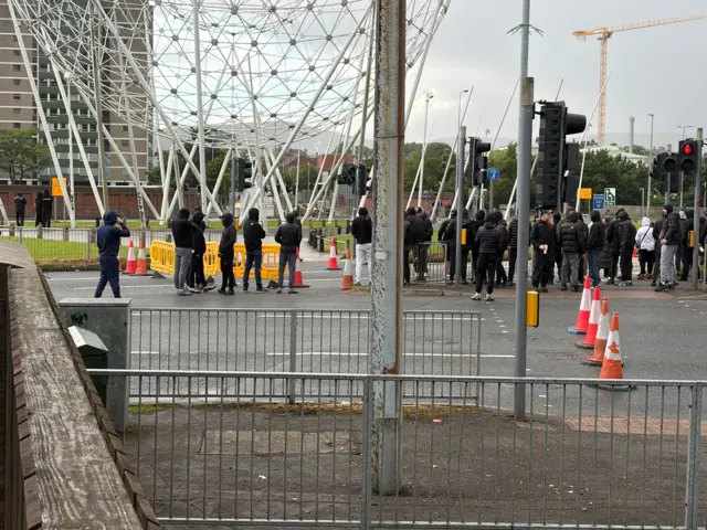Protesters gather at the Falls Road roundabout
