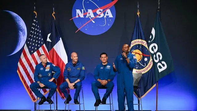Andre Douglas speaks on stage after being announced as the Artemis III mission specialist
