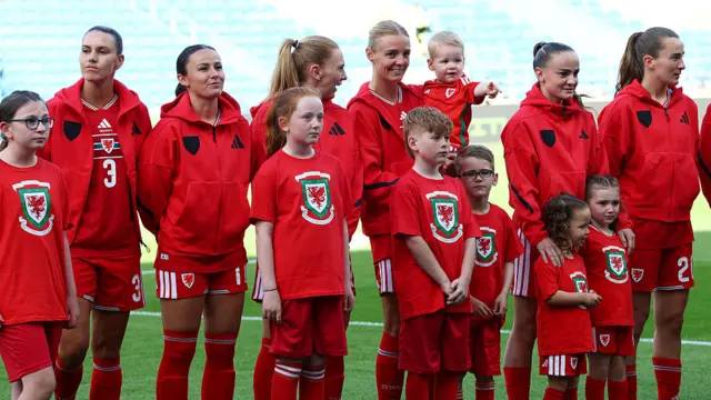 Wales players prepare to sing the national anthem
