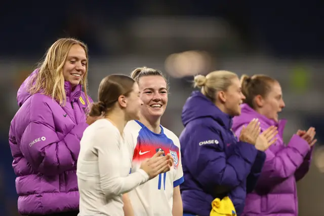 Lauren Hemp celebrates with teammates after final whistle