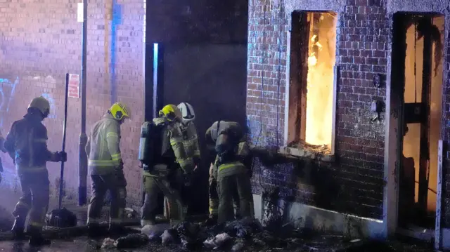 Firefighters attend a house which caught fire on Ligoniel Road, Belfast.