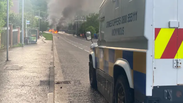 A fire on the road at thr front is a police landrover