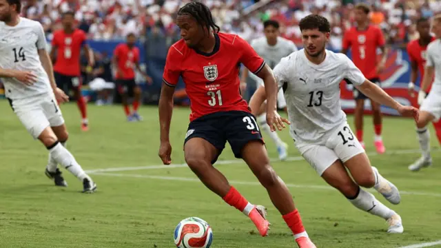 New Zealand defender Liberato Cacace (13) blocks the attack lane of England Ngumoha Rio (31)