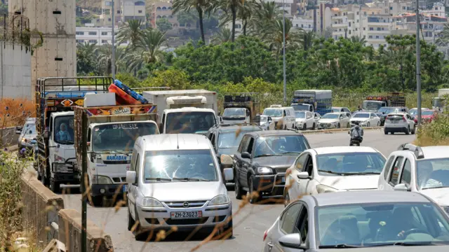 Vehicles wait in traffic as people flee from Tyre in southern Lebanon after Israel's evacuation warning