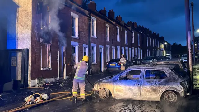 Firefighters attend a house which caught fire on Ligoniel Road, Belfast.