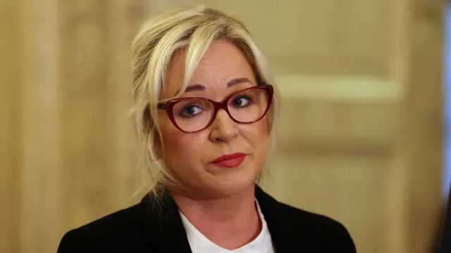 A blonde woman with glasses