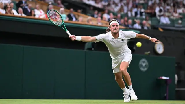 Stefanos Tsitsipas returns the ball