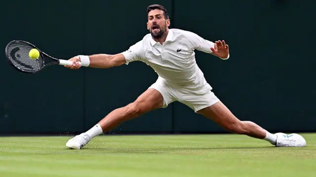 Novak Djokovic returns the ball