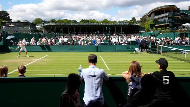 Spectators look over court 7
