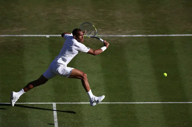 Felix Auger-Aliassime returns the ball