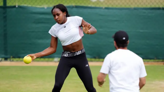 Coco Gauff catches a ball