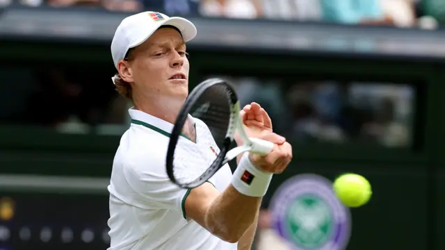 Jannik Sinner hits a forehand