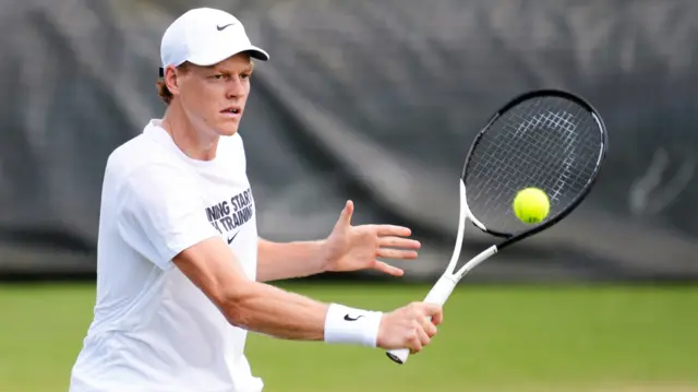 Jannik Sinner hits a backhand