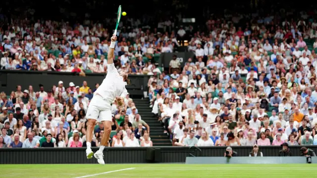 Stefanos Tsitsipas serves