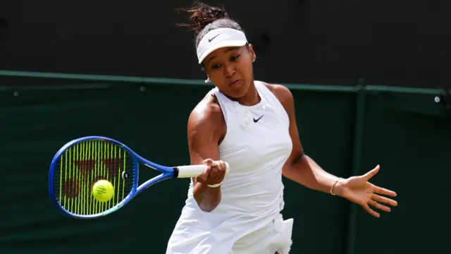Naomi Osaka hits a forehand
